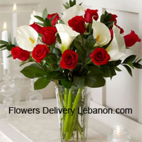 Red Roses And White Lilies With Some Ferns In A Glass Vase